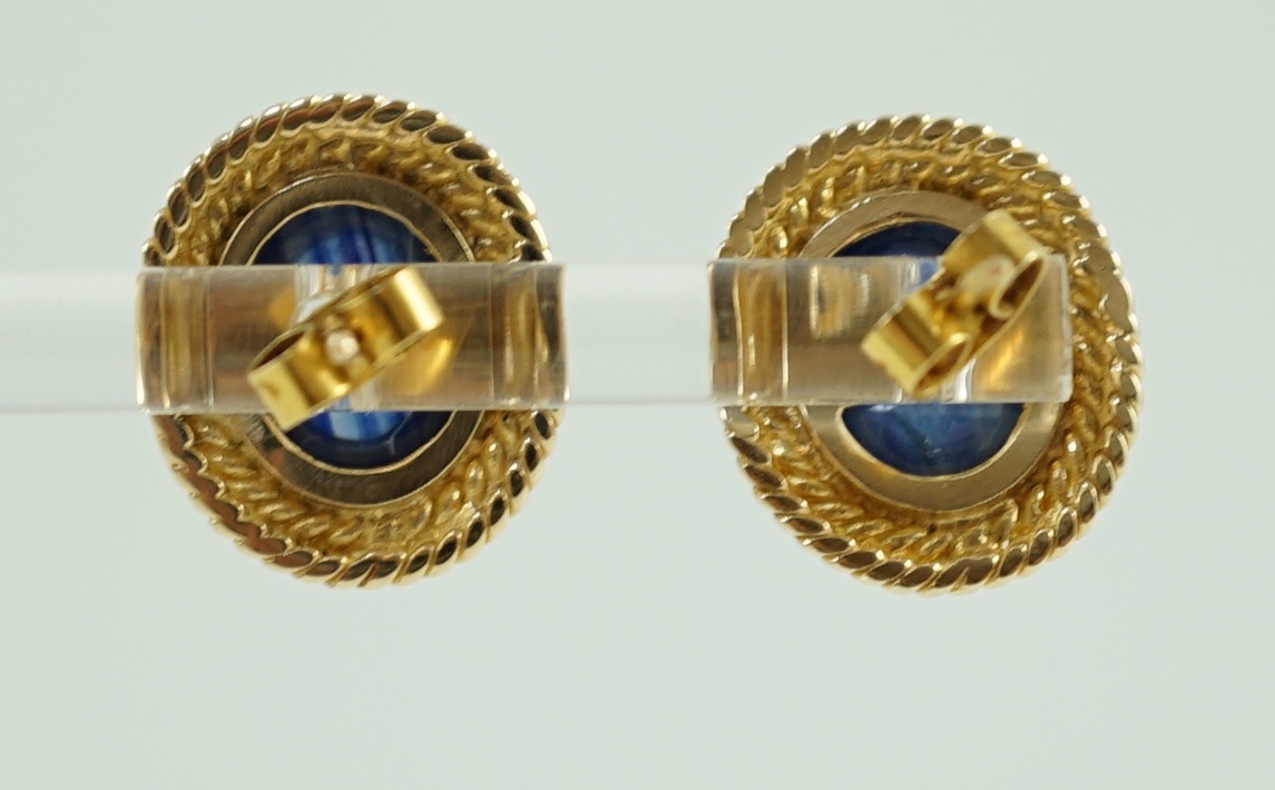 A 20th century pair of gold and cabochon sapphire set oval earrings